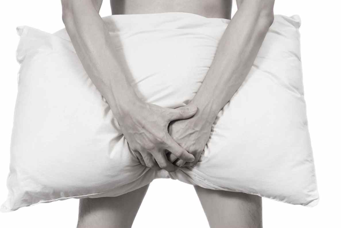 Man with hands on stomach